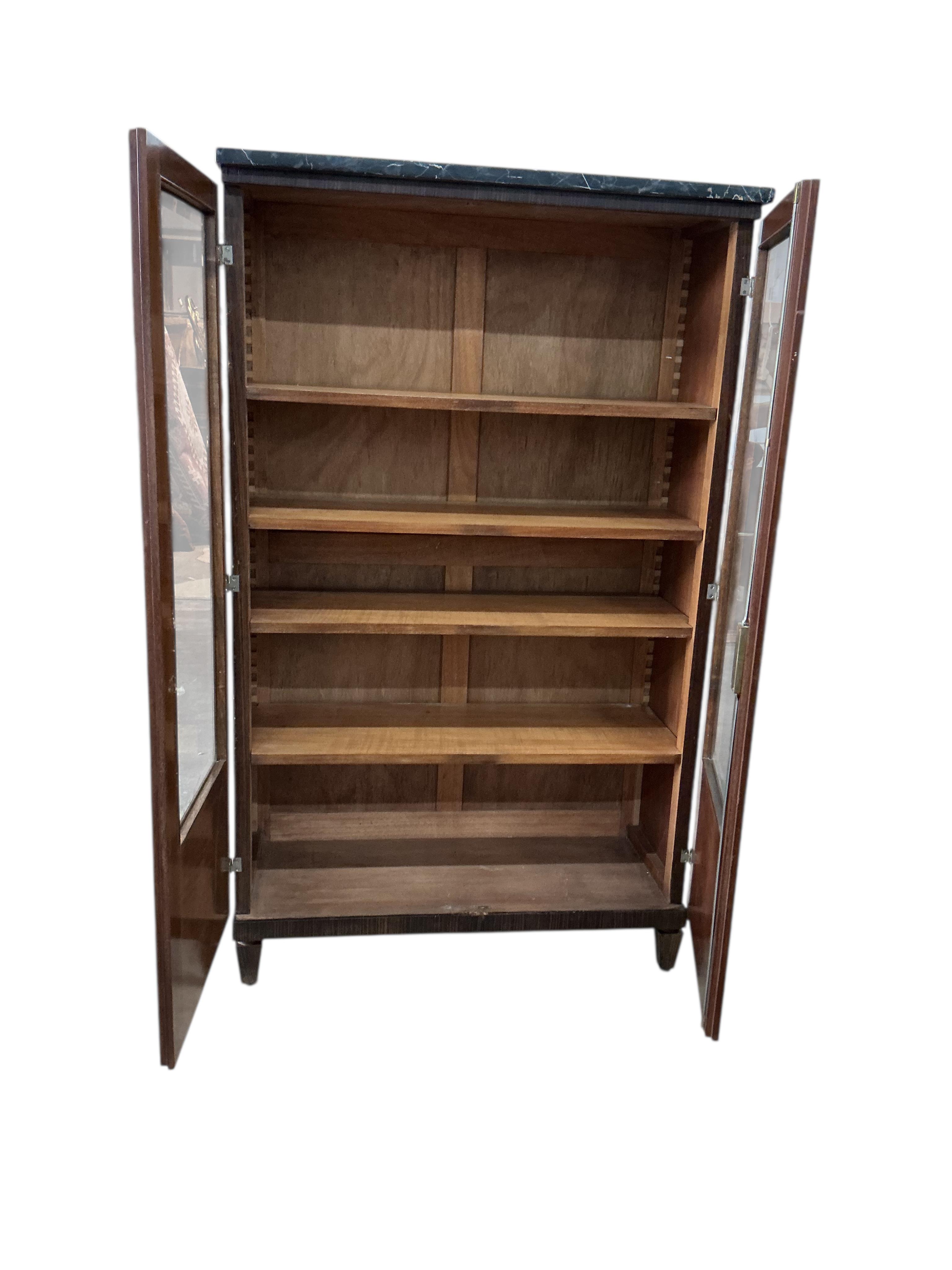 A French Art Deco marble topped coromandel bookcase, width 92cm, depth 38cm, height 151cm